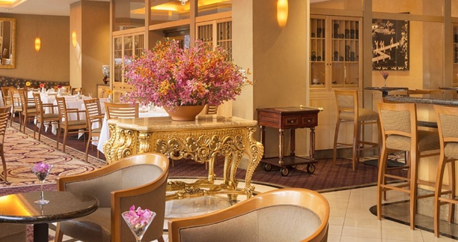 Orchard Daffodil restaurant with tables and chairs and pink floral arrangements